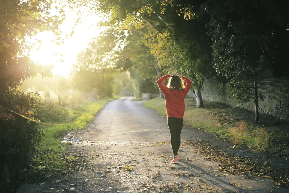 Woman walking down a dirt road