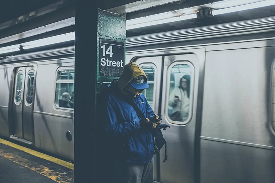 Man on a phone waiting in a subway station
