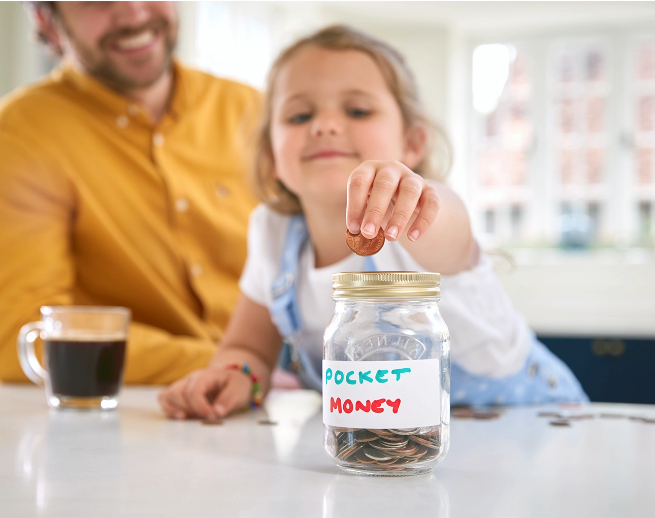 child depositing money into jar