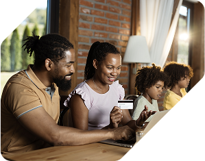 A couple entering their card information on a laptop