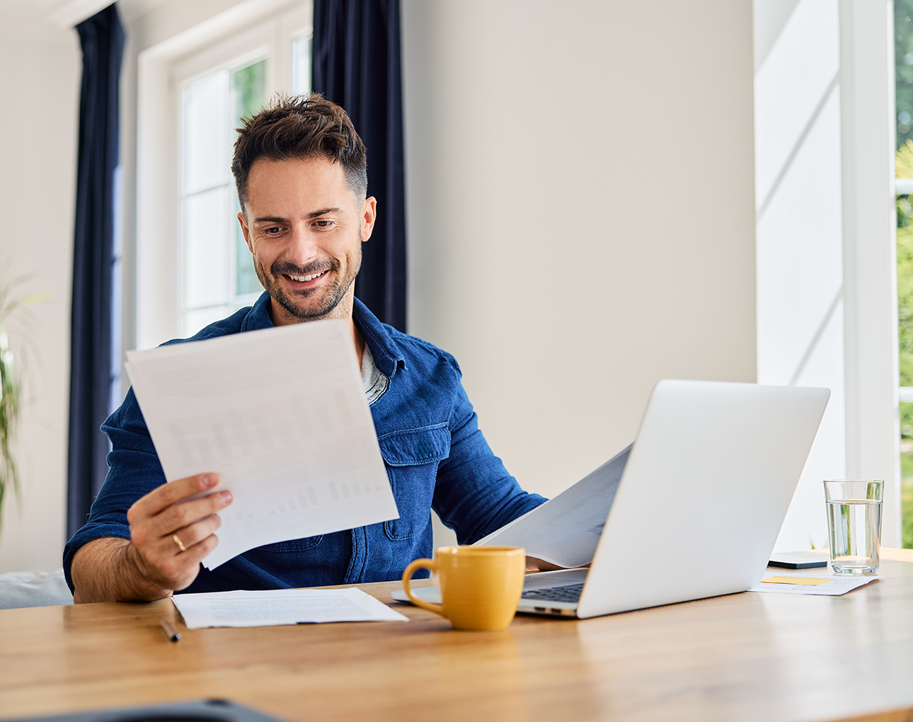 Man looking at laptop, opening a share certificate