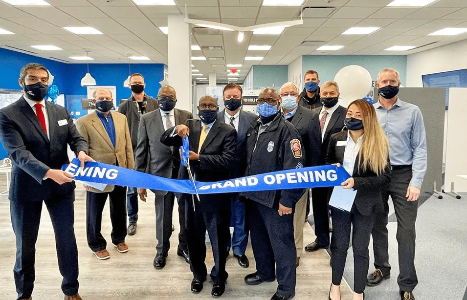 Andrews team members cutting a ribbon at new location