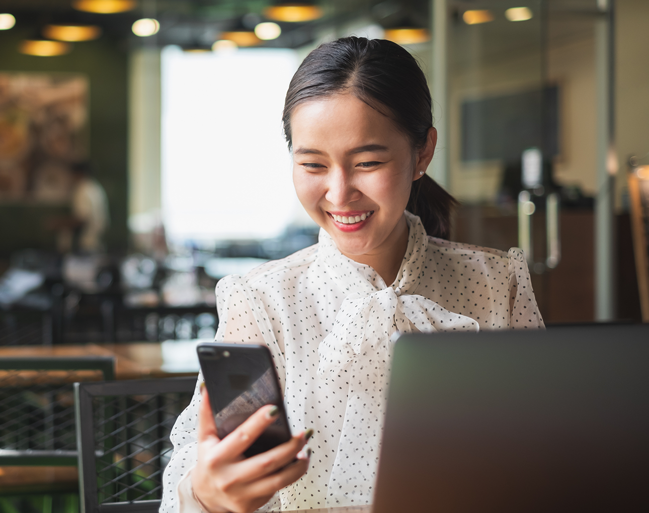 woman looking at her smart phone