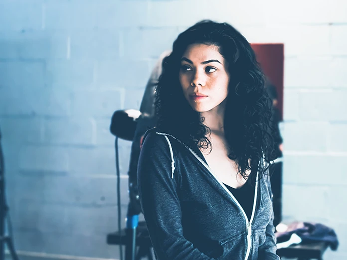 Woman sitting down looking behind her