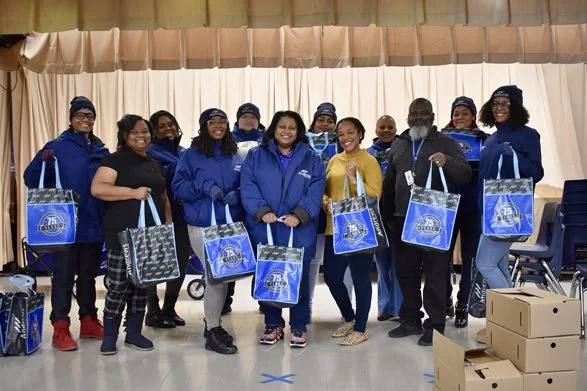Members of the Andrews team holding donation bags