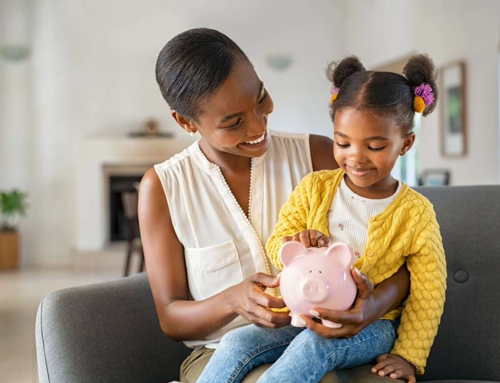 Mother and daughter with a piggy bank