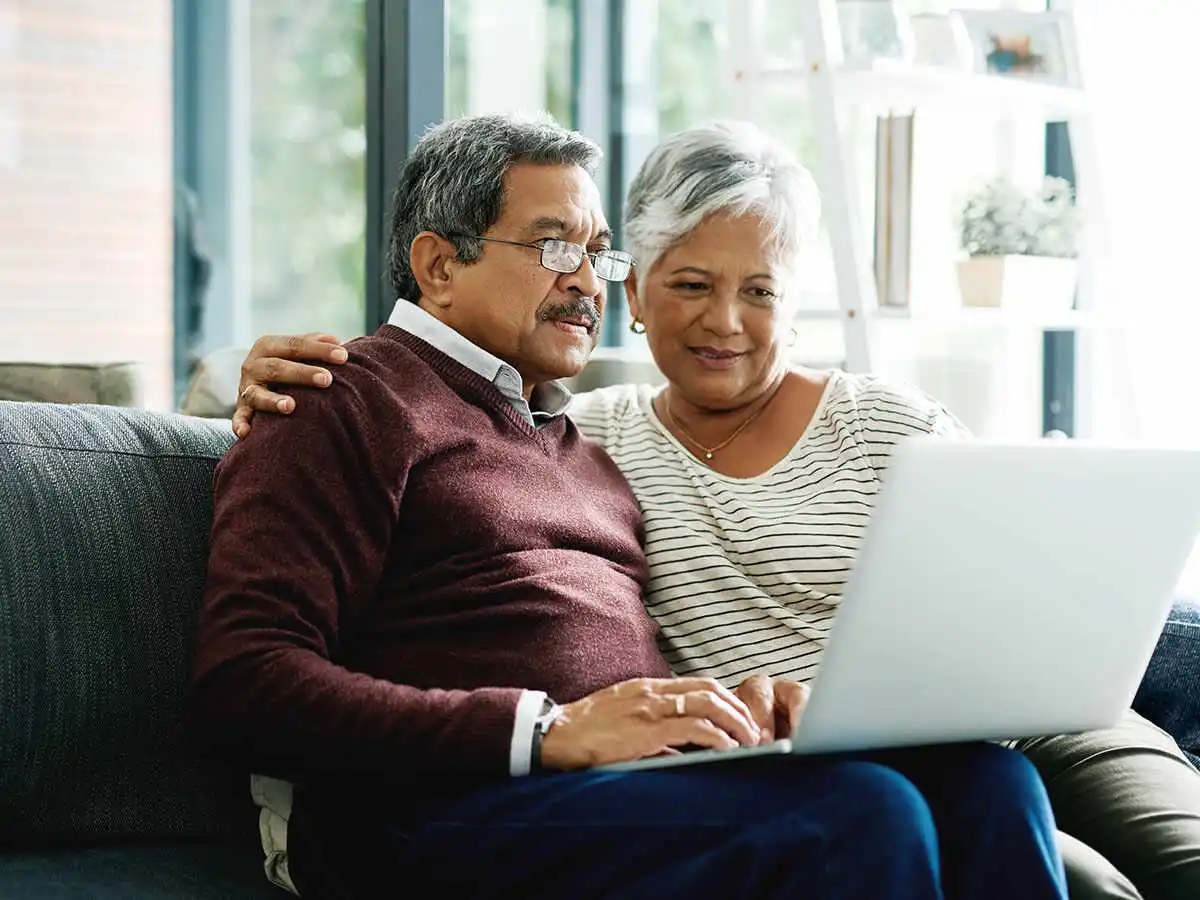 Elderly couple looking at a laptop